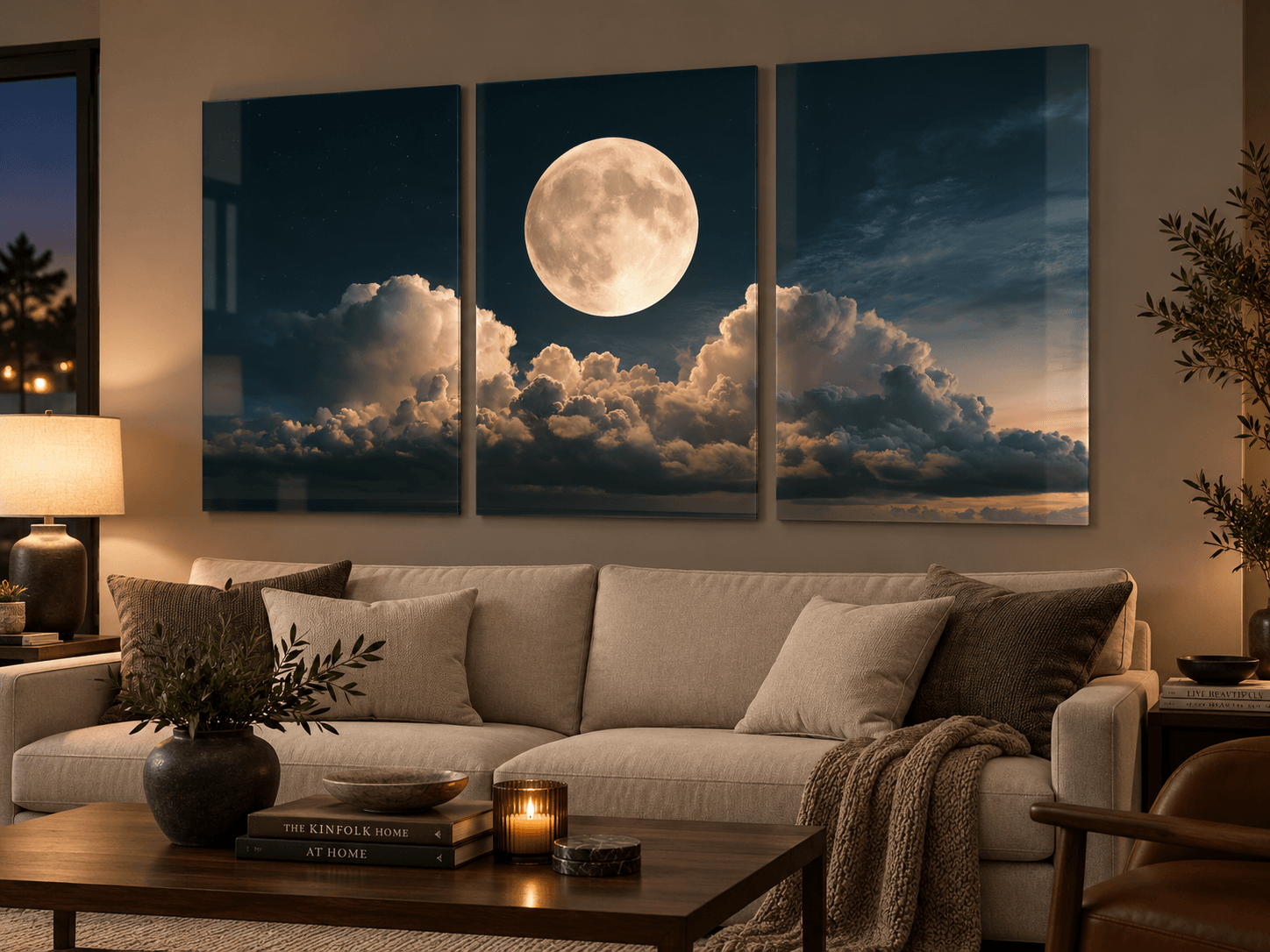 Three-panel moonrise glass art above a taupe sofa in a cozy evening living room